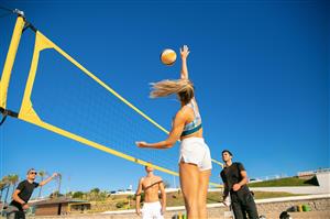 Co-ed Beach Volleyball with a clear blue sky as a background